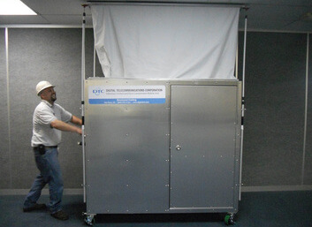 Employee in Hard Hat Pushing the Infectious Control and Dust Containment Mobile Unit