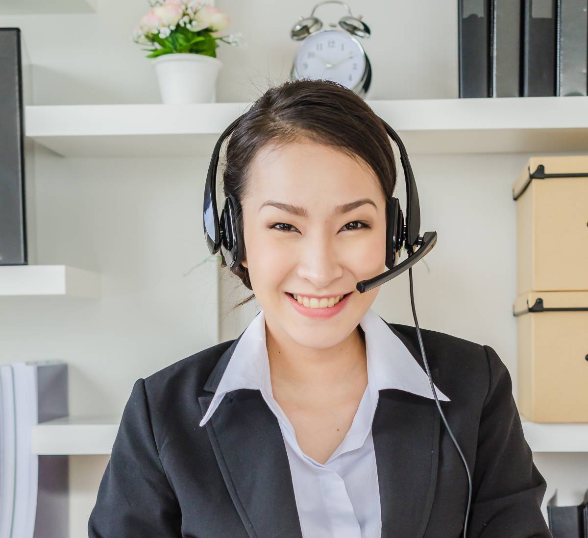 A businesswoman using a headset to communicate with customers