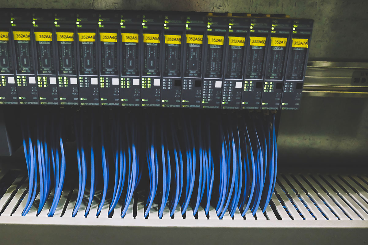 Blue cables in control panel system server rack.