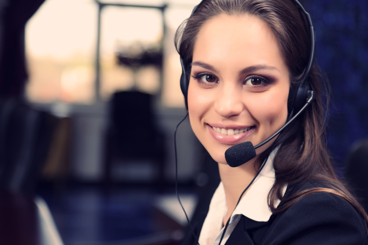 A person with a phone headset smiling