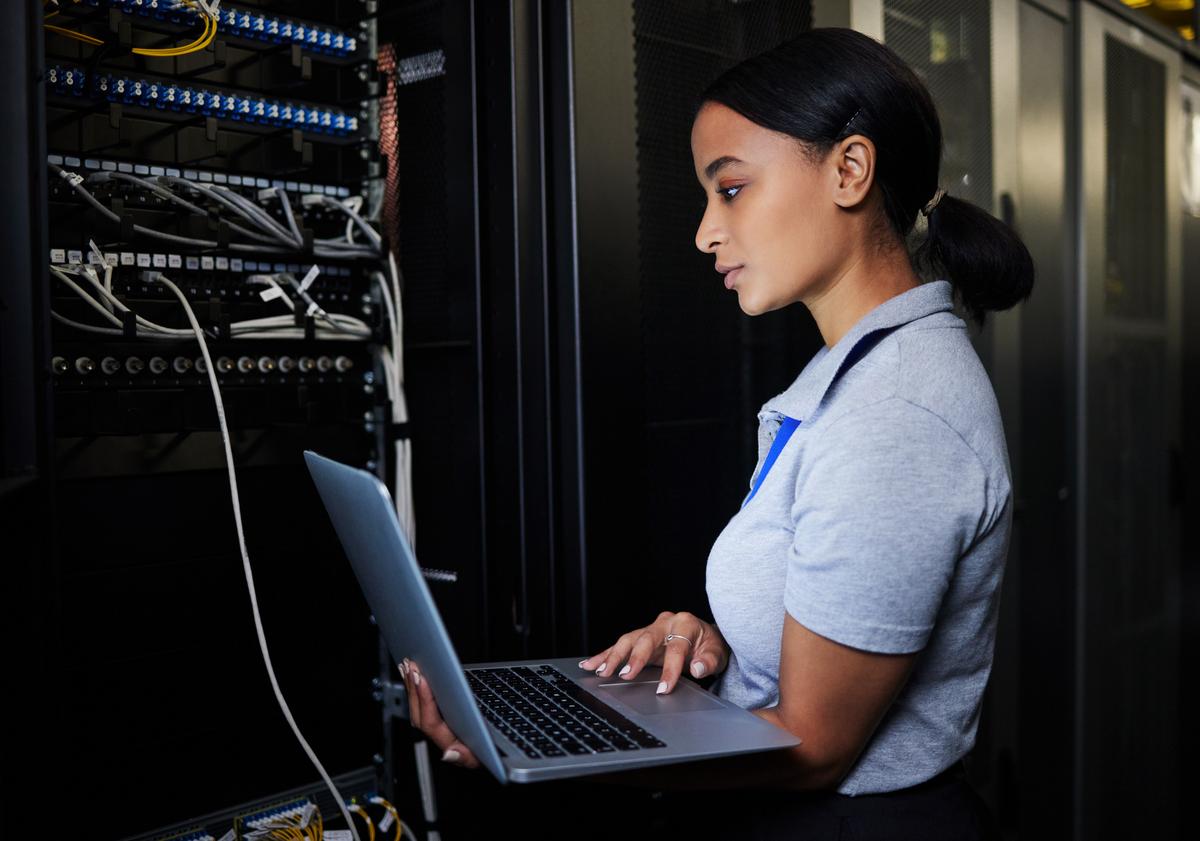 Woman checking things in network server room