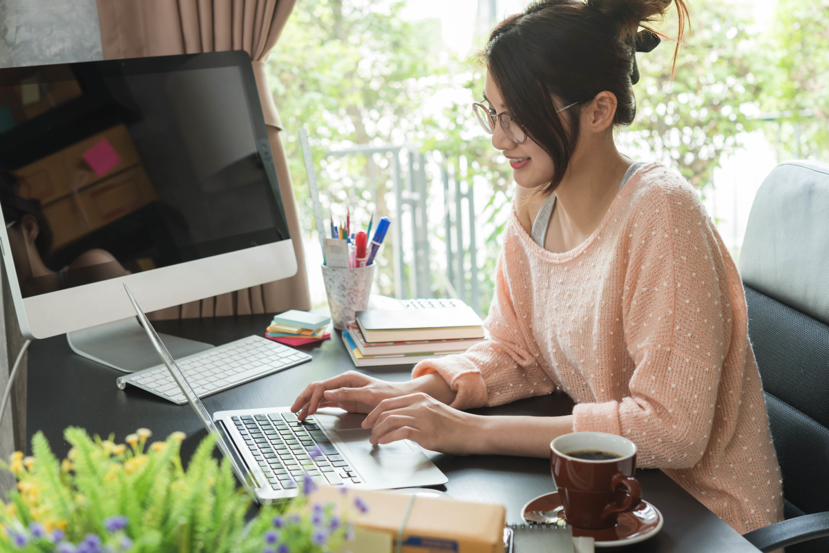 A woman working remotely on her laptop