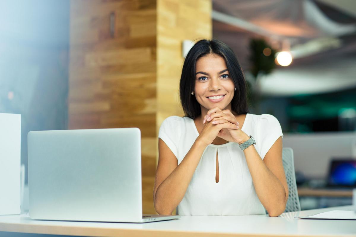 Smiling woman sitting at an office desk