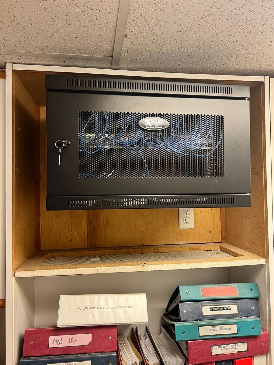 Cable closet after remodel: organized patch panels, professionally routed cables, clean installation