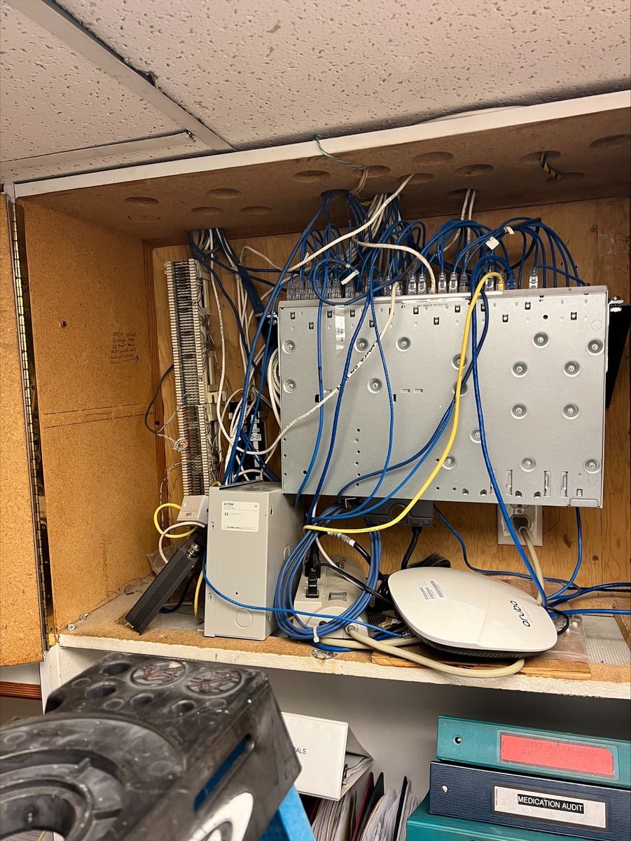 Cable closet before remodel: tangled cables, messy wiring without organization