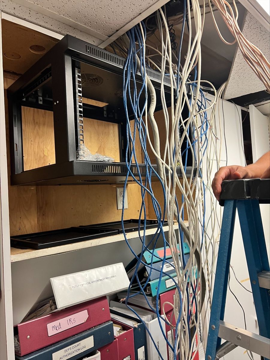 Mid-installation showing cable management and patch panel setup