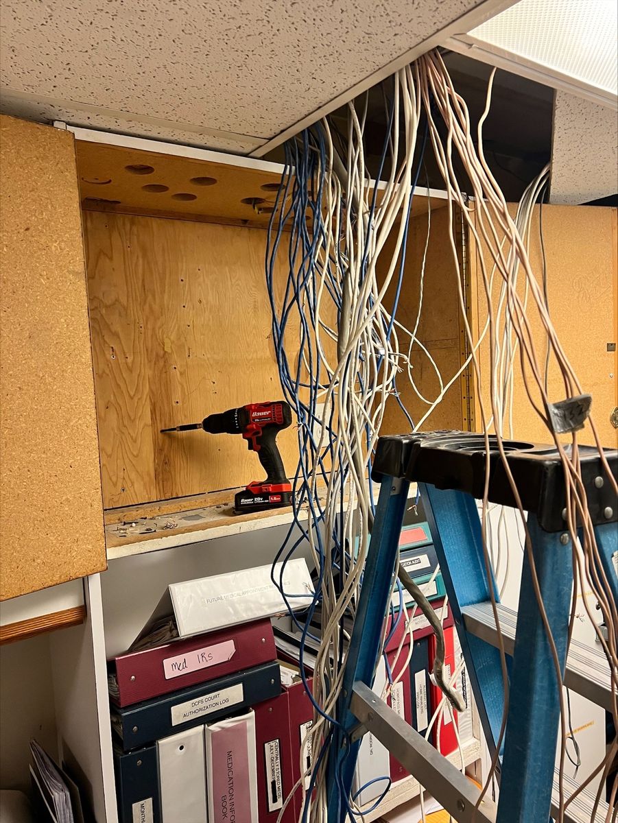 Installation work in progress with cables actively being routed